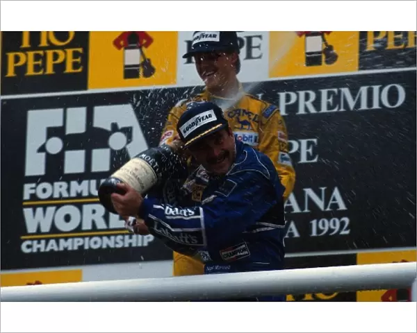 Formula One World Championship: Race winner Nigel Mansell celebrates his victory with Michael Schumacher on the podium