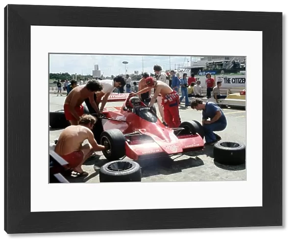 Formula One World Championship: Mechanics go about changing tyres on the radical new Brabham BT46 of third placed John Watson, which featured