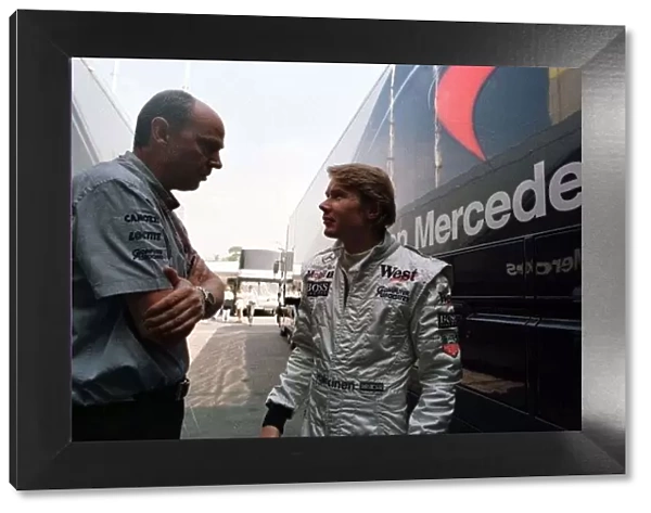 1997 SPANISH GP. McLaren Mercedes driver MIka Hakkinen chats to his head engineer
