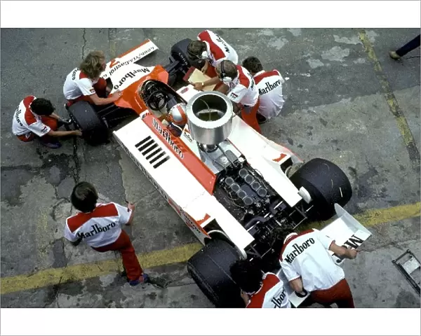 Formula One World Championship: McLaren mechanics work on the car of John Watson McLaren Cosworth M29 in the pits