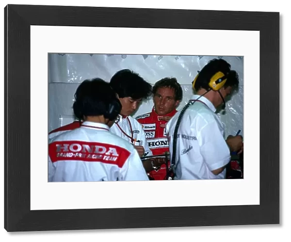 Formula One World Championship: Gerhard Berger McLaren confers with the Honda engineers in the pit garage