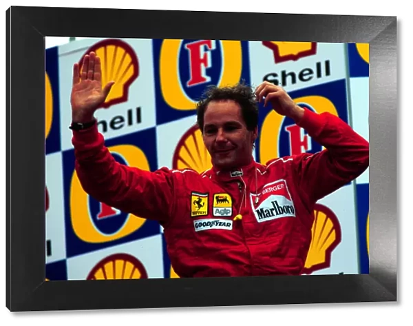 1995 SAN MARINO GP. Gerhard Berger celebrates on the podium after coming 3rd at Imola