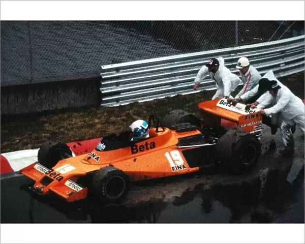 Formula One World Championship: Beppe Gabbiani Surtees TS20 is pushed back onto the circuit by marshals after spinning in the wet practice session