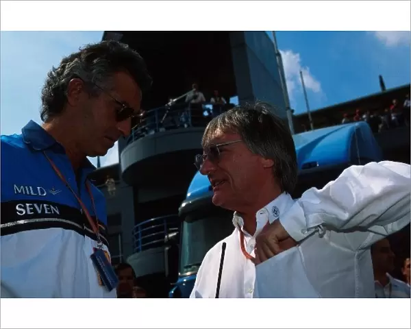 Formula One World Championship: Flavio Briatore Benetton F1 Boss talks with Bernie Ecclestone F1 Supremo, right