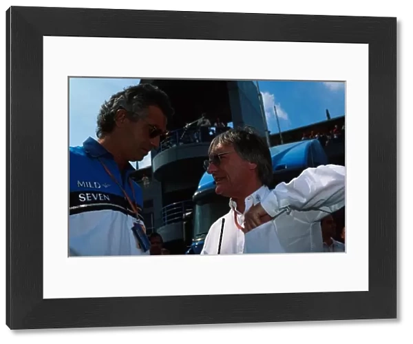 Formula One World Championship: Flavio Briatore Benetton F1 Boss talks with Bernie Ecclestone F1 Supremo, right