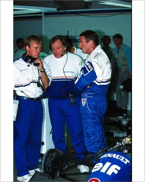 Formula One World Championship: Nigel Mansell talks with the Williams race engineers, David Brown, left, and Patrick Head