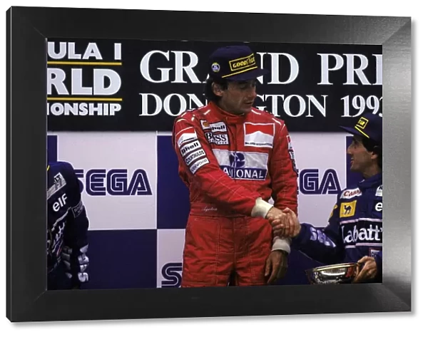 Formula One World Championship: The podium: Race winner Ayrton Senna McLaren shakes hands with archrival Alain Prost Williams, who had finished
