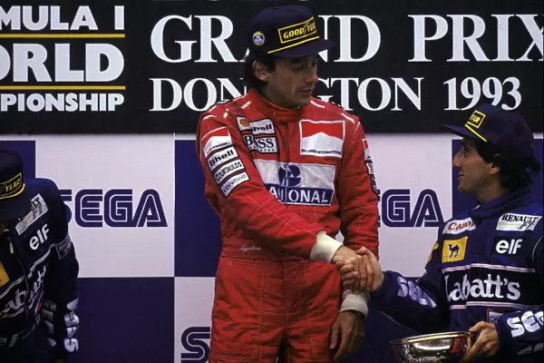 Formula One World Championship: The podium: Race winner Ayrton Senna McLaren shakes hands with archrival Alain Prost Williams, who had finished