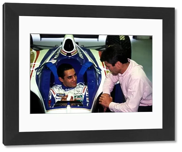 Formula One World Championship: Juan Pablo Montoya sits in a Williams Renault FW19 chatting to Williams Engineer James Robinson