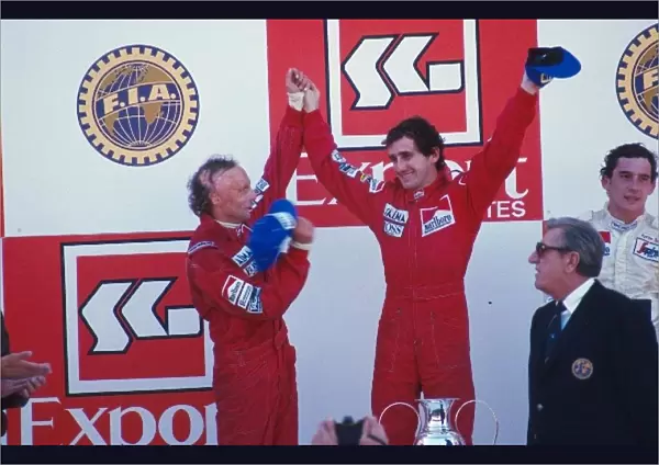 Formula One World Championship: winner Alain Prost, centre, with second place Niki Lauda, left, and third place Ayrton Senna, right