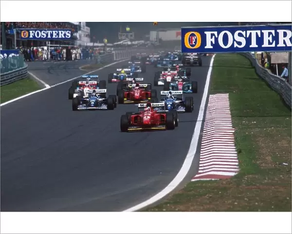 Formula One World Championship: Gerhard Berger Ferrari 412T1B leads at the start from the Williams of Coulthard and Hill, left