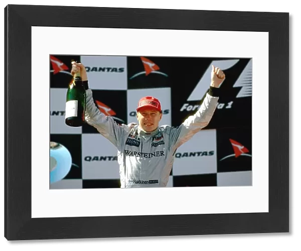 Formula One World Championship: Mika Hakkinen McLaren celebrates his second Grand Prix victory on the podium, albeit in controversial circumstances