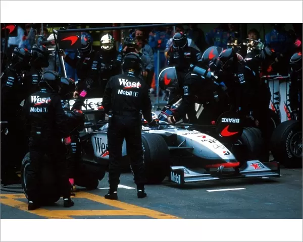 Formula One World Championship: David Coulthard McLaren Mercedes MP4  /  13 makes a pitstop on his way to 2nd place