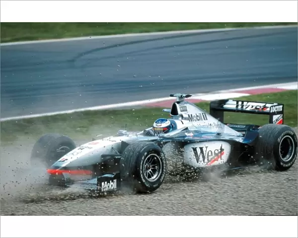 Formula One World Championship: Mika Hakkinen Mclaren MP4-13 spins off into the gravel