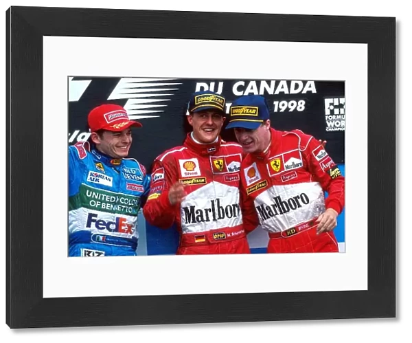 Formula One World Championship: Giancarlo Fisichella Benetton, Winner Michael Schumacher Ferrari and Eddie Irvine Ferrari