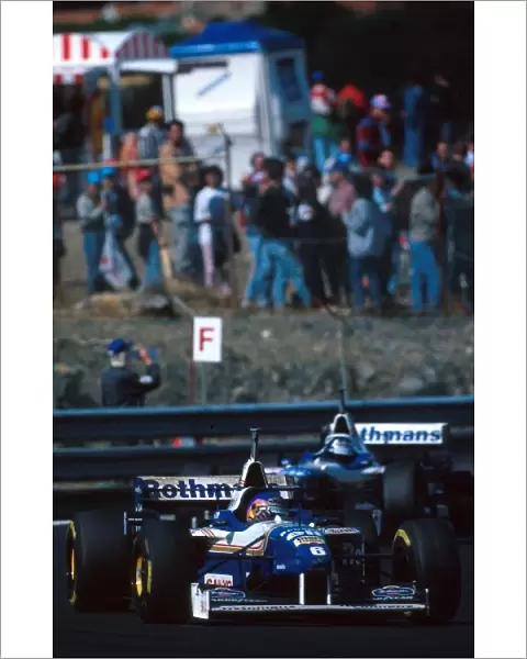 Formula One World Championship: Winner Jacques Villeneuve Williams FW18 leads team mate Damon Hill, 2nd place