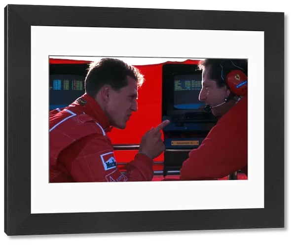 Formula One World Championship: Michael Schumacher Ferrari F310 makes a point to Jean Todt