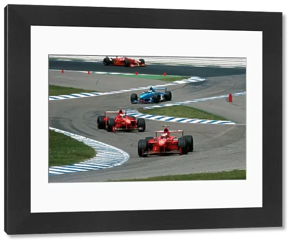 Formula One World Championship: Michael Schumacher, Ferrari F300, 5th place, leads team-mate Eddie Irvine, Ferrari F300
