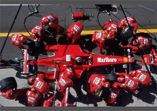 Formula One World Championship: Michael Schumacher Ferrari F300 makes a pit stop