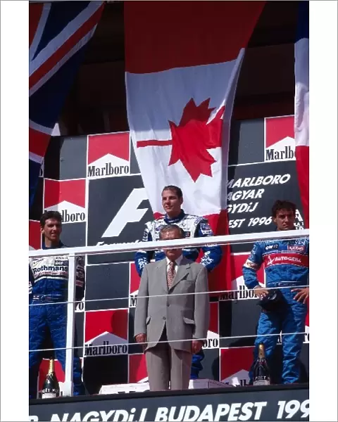 Formula One World Championship: On the podium: Damon Hill Williams second, Jacques Villeneuve Williams first and Jean Alesi Benetton third