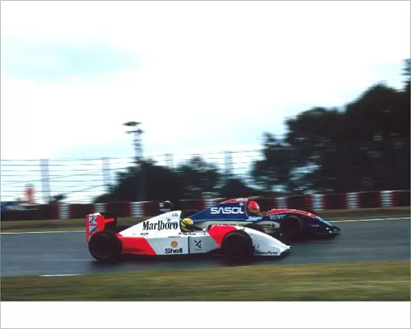 Formula One World Championship: Ayrton Senna McLaren Ford MP4  /  8 passes Eddie Irvine Jordan Hart J193 on the way to the win