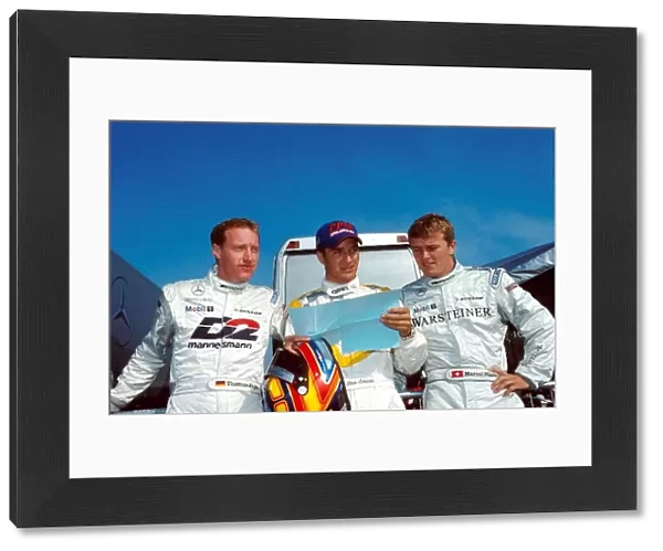 DTM Championship: Timo Scheider, centre, consults with Mercedes drivers Marcel Faessler, right and Thomas Jaeger, left