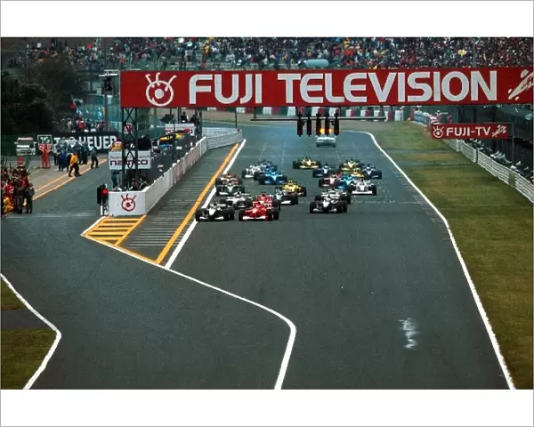 Japanese GP Formula One World Championship: The start of the race. Mika Hakkinen gets the jump on Schumacher and the rest of the field