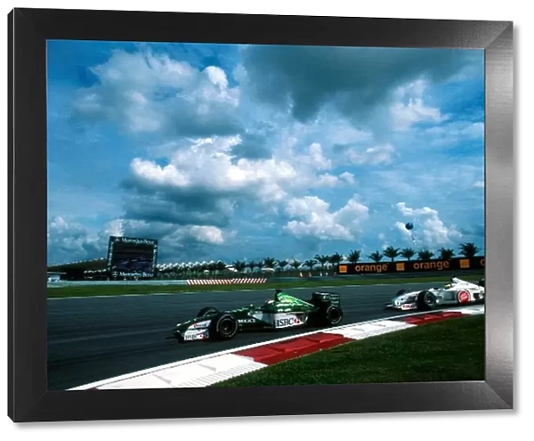 Formula One World Championship: Eddie IrvineJaguar Cosworth R1 leads Ricardo ZontaBAR Honda 002