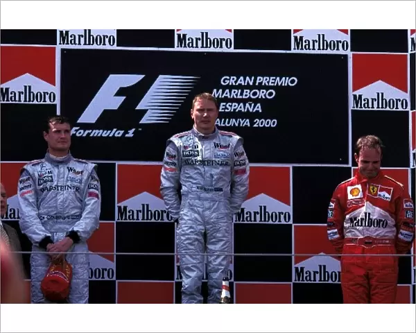 Formula One World Championship: The podium finishers David Coulthard McLaren 2nd, Mika Hakkinen McLaren 1st, Rubens Barrichello Ferrari 3rd