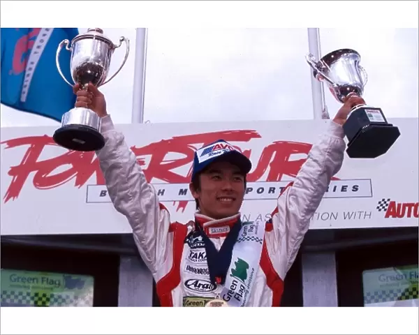 British Formula Three Championship: Race winner Takuma Sato Carlin Motorsport celebrates on the podium after taking his first Formula Three victory