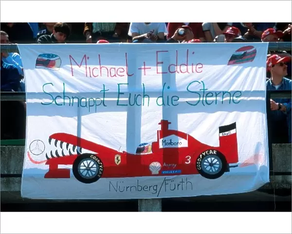 Formula One World Championship: A Ferrari fans banner depicting the Ferrari team devouring Mercedes