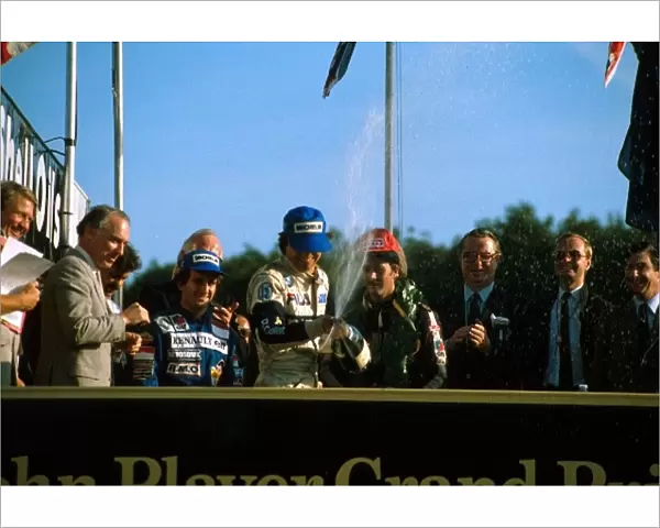 Formula One World Championship: Winner Nelson Piquet sprays the champagne as 2nd place Alain Prost left, and Nigel Mansell, right look