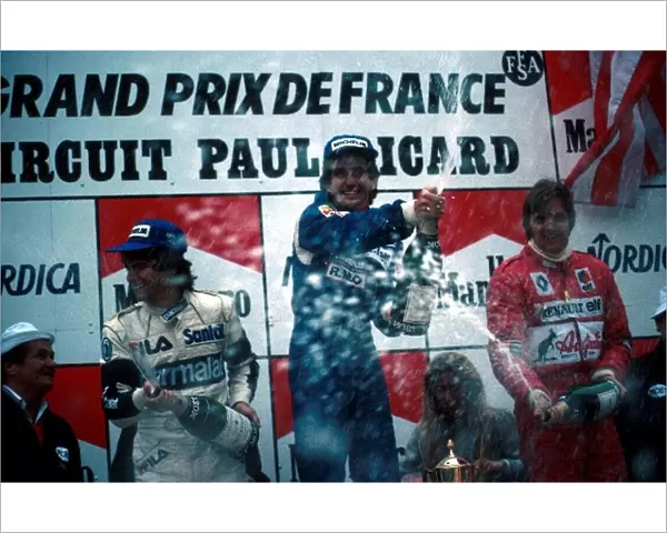 Formula One World Championship: Winner Alain Prost, centre, second place Nelson Piquet, left, and third place Eddie Cheever spray the champagne