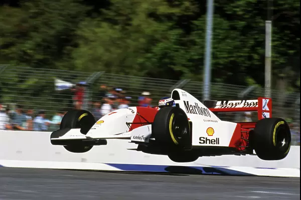 Formula One World Championship: The Flying Finn Mika Hakkinen launches his Mclaren MP4  /  8 into the air at the Malthouse Corner during a lap in
