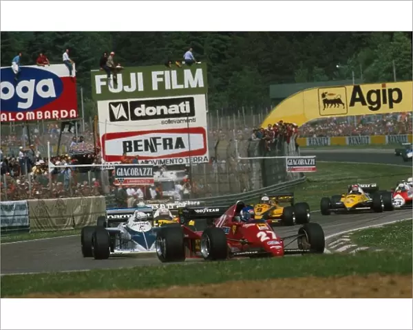 Formula One World Championship: The Ferrari of race winner Patrick Tambay leads the pack into the first corner, followed by the Brabham of Riccardo