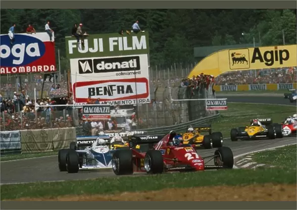 Formula One World Championship: The Ferrari of race winner Patrick Tambay leads the pack into the first corner, followed by the Brabham of Riccardo