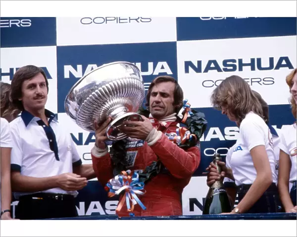 Formula One World Championship: Race winner Carlos Reutemann, Williams, with his trophy on the podium
