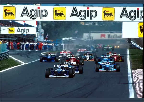 Formula One World Championship: David Coulthard leads at the start of the race whilst Katayama and Badoer collide at the back of the grid