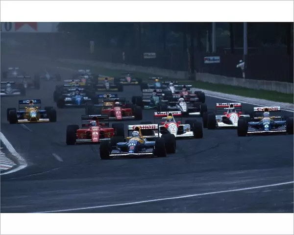 Formula One World Championship: Nigel Mansell Williams FW14 leads the field at the start of the race