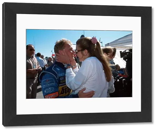 Formula One World Championship: Johnny Herbert is embraced by his wife Becky after his excellent 2nd place