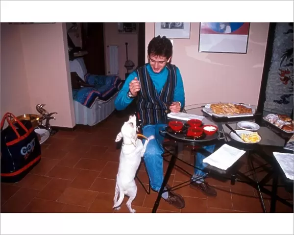 Formula One Drivers at Home Feature: Jarno Trulli at home teasing his pet dog as dinner is about to be served