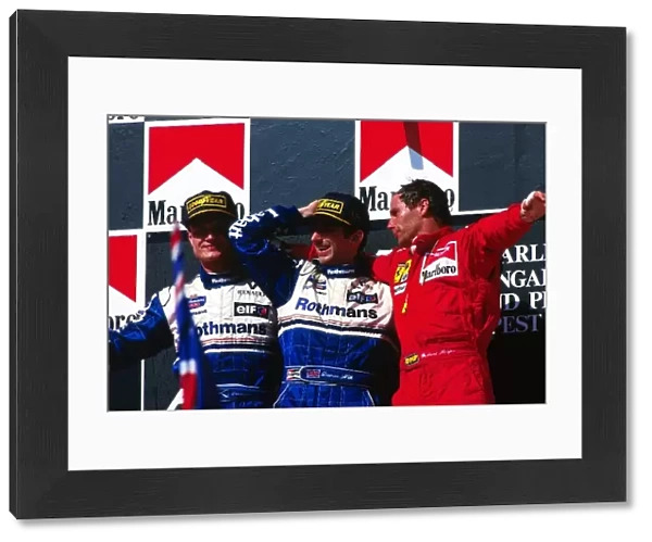 Formula One World Championship: The podium: David Coulthard Williams second; Damon Hill Williams winner; Gerhard Berger Ferrari third