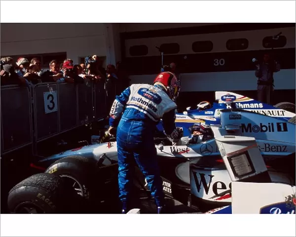 Formula One World Championship: Winner Jacques Villeneuve Williams FW19 celebrates with David Coulthard Mclaren