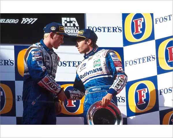 Formula One World Championship: Race winner Jacques Villeneuve shakes hands with his Williams team mate Heinz-Harald Frentzen who finished third