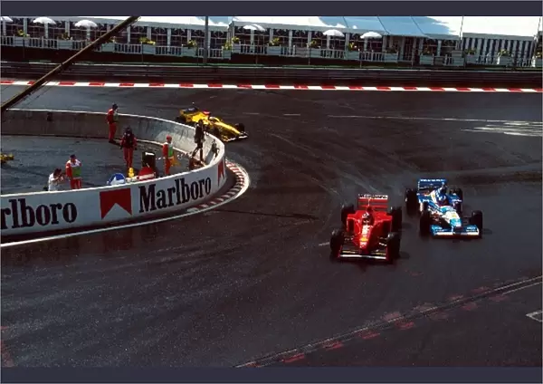 Formula One World Championship: Michael Schumacher Ferrari F310B overtakes Jean Alesi Benetton