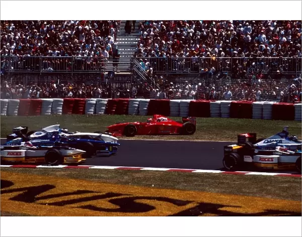 Formula One World Championship: Eddie Irvine, Ferrari F310B, DNF comes off worst in the scramble for turn 1