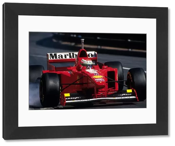 Formula One World Championship: Eddie Irvine, Ferrari F310B 3rd place locks a wheel in practice