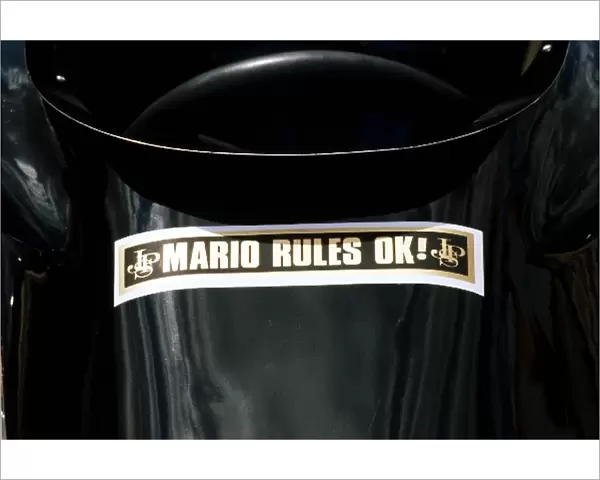 Formula One World Championship: The Lotus 78 of Mario Andretti, who retired from the race on lap 63 with a blown engine, carries a message of
