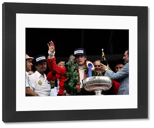 Formula One World Championship: Niki Lauda celebrates on the podium his first victory since his near-fatal accident at the Nurburgring the previous