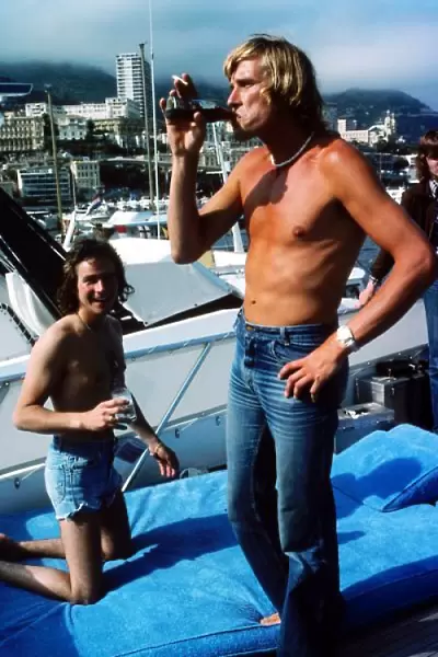 Formula One World Championship: Reigning World Motorcycle Champion Barry Sheene on a boat with reigning World Formula One Champion James Hunt McLaren